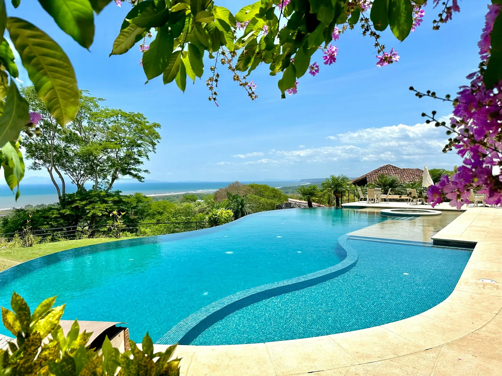 a large swimming pool with a view of the ocean