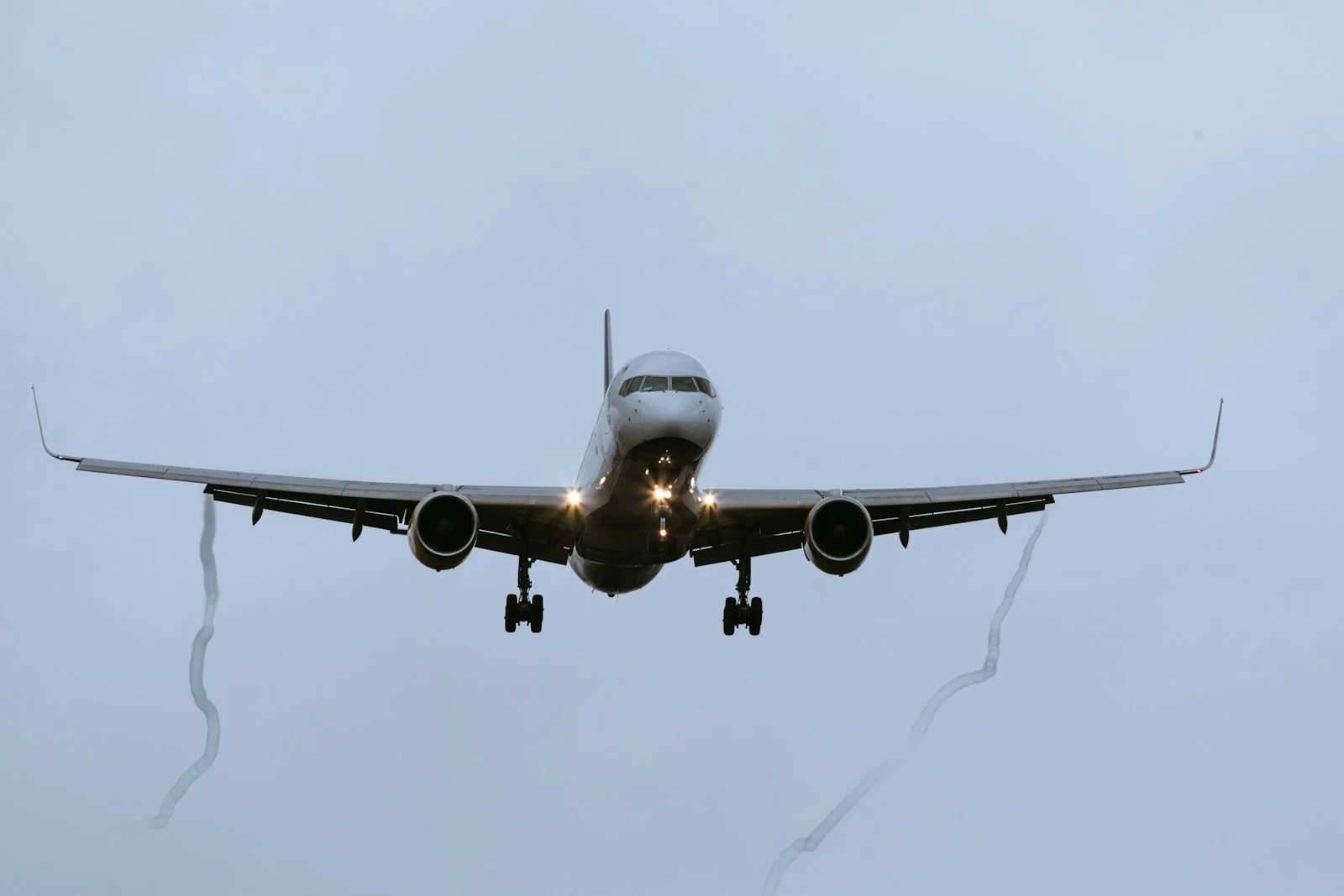 a large jetliner flying through a cloudy sky